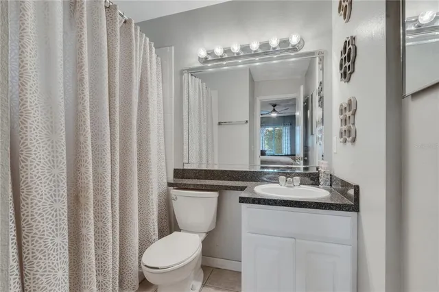 a bathroom with a toilet a sink and a mirror