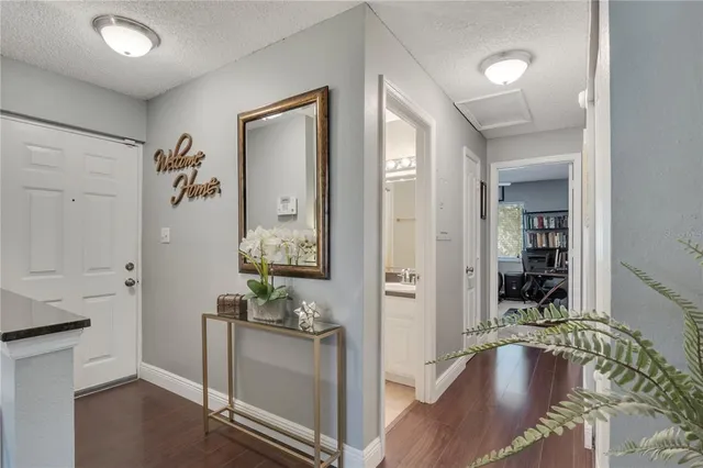 wooden floor with table and chairs