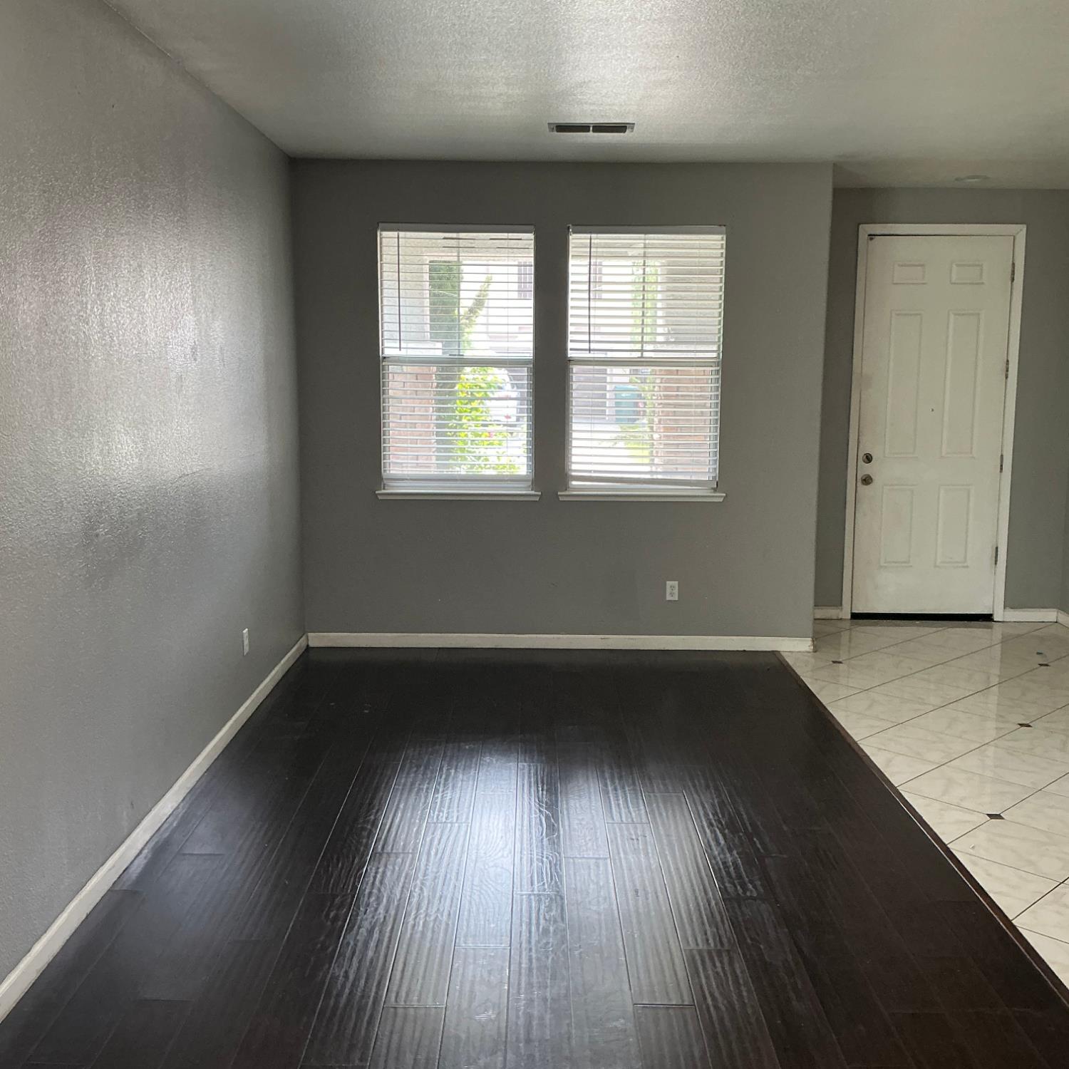 7784 Megan Ann Way Antelope, CA 95843 - Photo 2 of 20 an empty room with wooden floor and windows