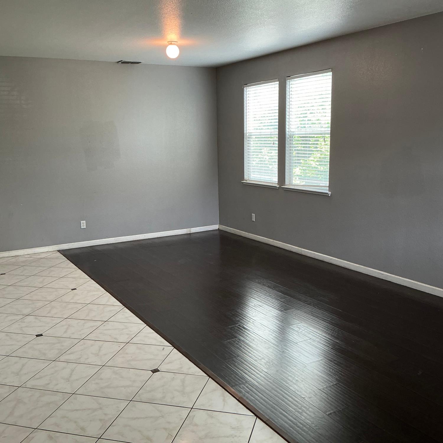 7784 Megan Ann Way Antelope, CA 95843 - Photo 3 of 20 en empty room with wooden floor and windows