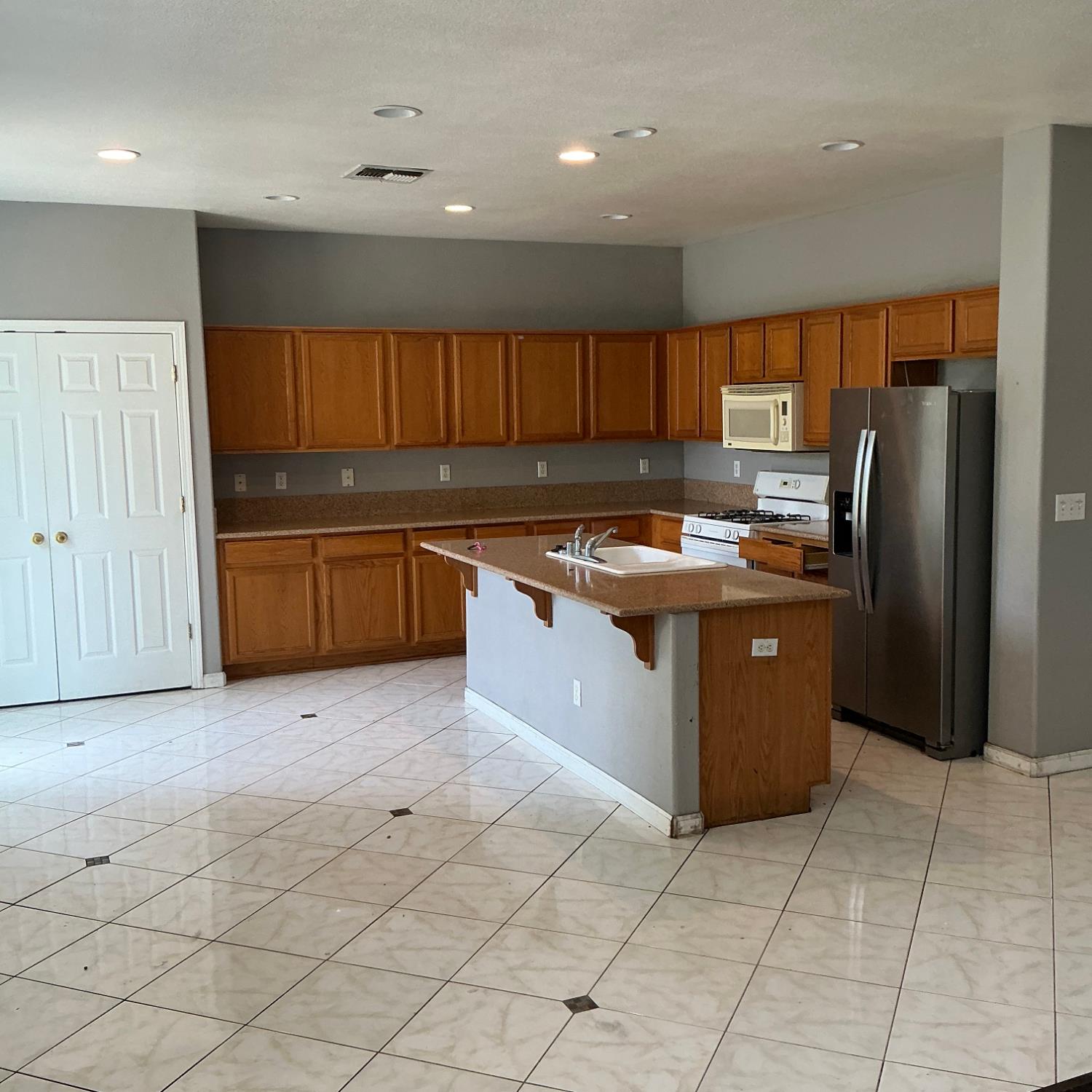 7784 Megan Ann Way Antelope, CA 95843 - Photo 6 of 20 a kitchen with stainless steel appliances granite countertop a stove a sink and a refrigerator