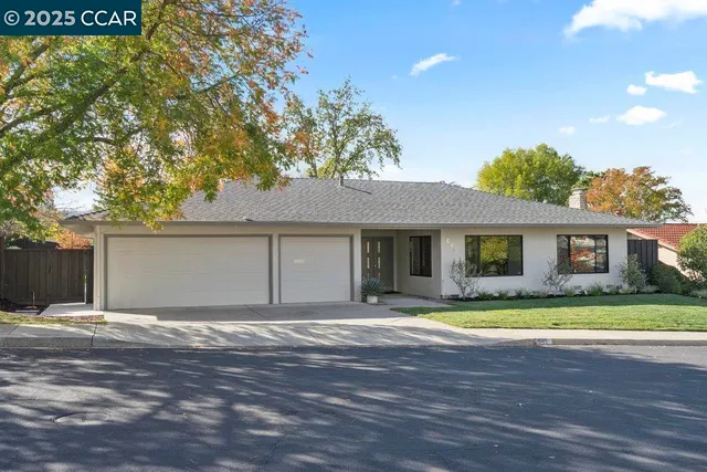 a view of a house with a patio and a yard