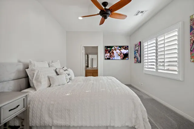 a bathroom with a sink a toilet a mirror and shower