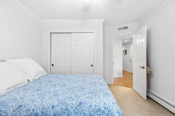 a bedroom with a bed couch and window