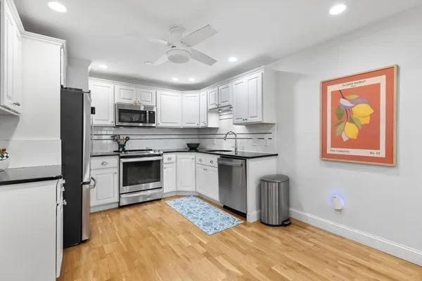 a dining room with furniture window and wooden floor