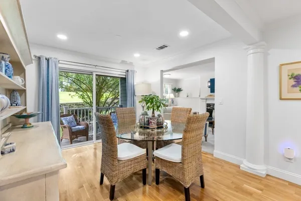 a living room with furniture a flat screen tv and a floor to ceiling window