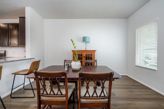 a bedroom with a bed and a flat tv screen on dresser