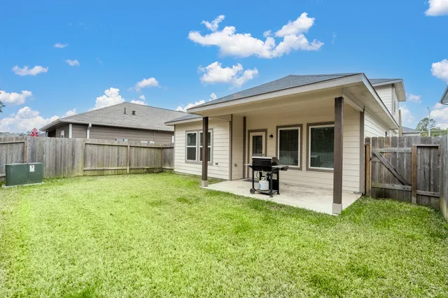a view of a house with a backyard porch and sitting area