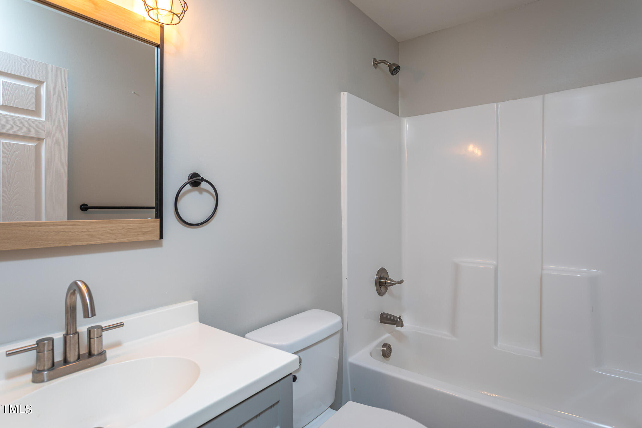 703 Woodland Road Raleigh, NC 27603 - Photo 15 of 26 a bathroom with a sink toilet and shower