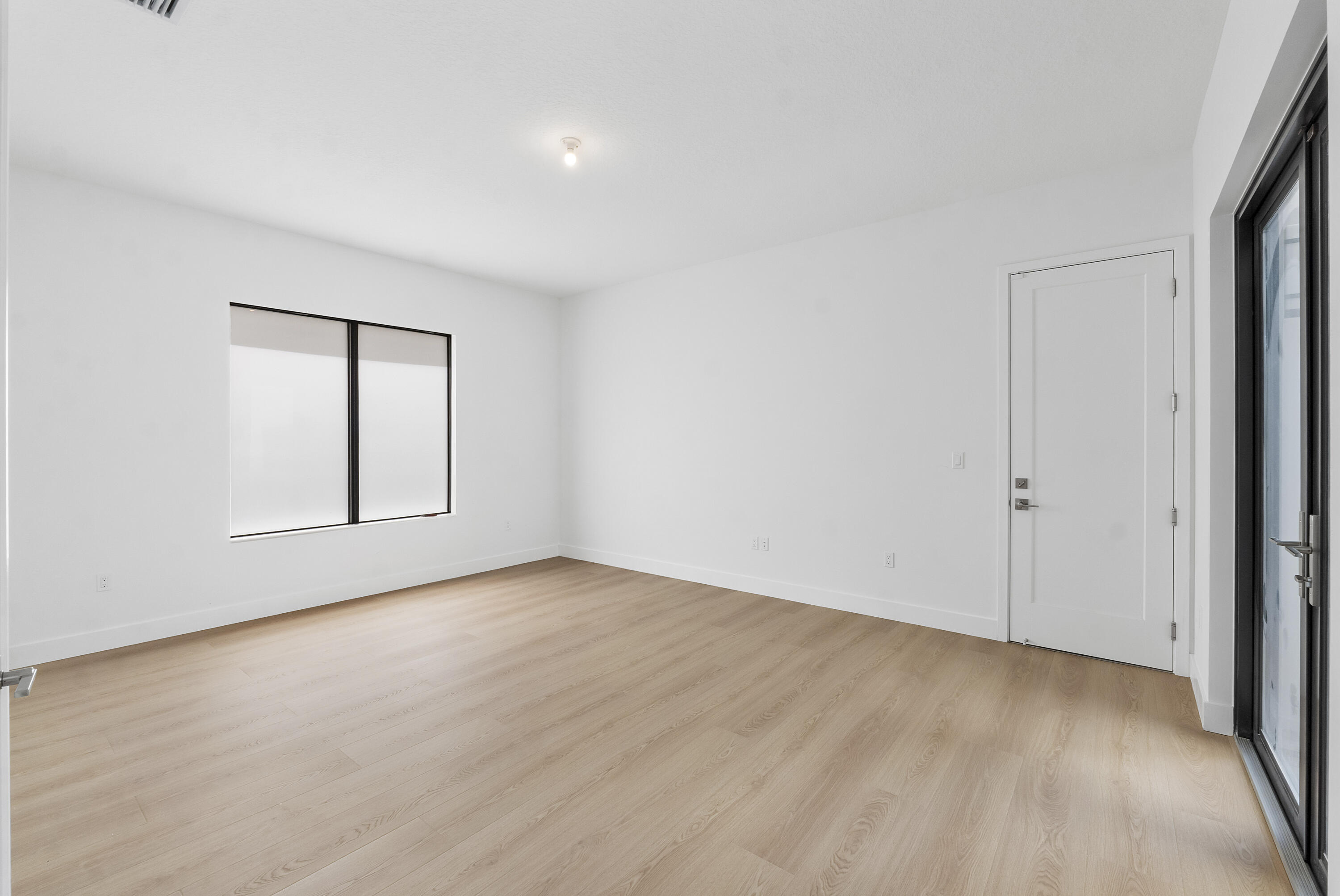 9322 Sunflower Mdw Road Boca Raton, FL 33434 - Photo 23 of 87 an empty room with wooden floor and windows