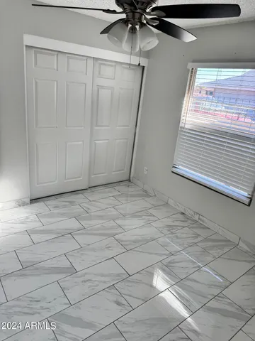 a view of a livingroom with a ceiling fan and window