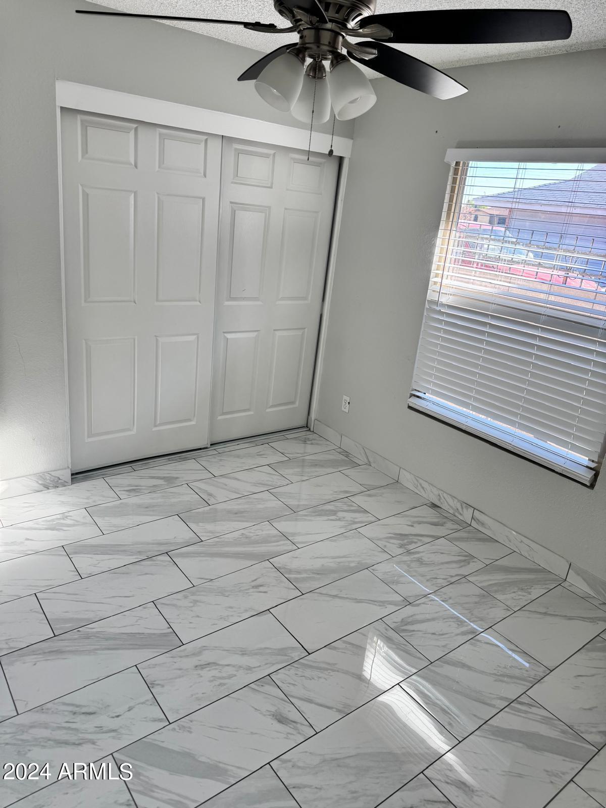 7209 West Luke Avenue Glendale, AZ 85303 - Photo 11 of 19 a view of a livingroom with a ceiling fan and window