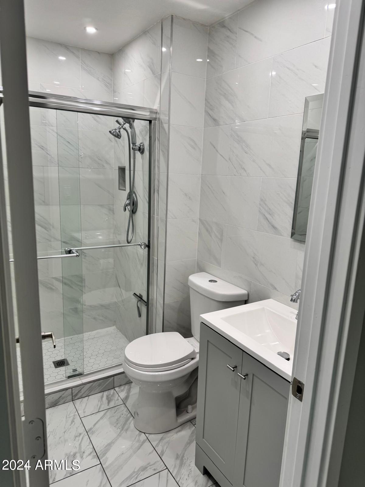 7209 West Luke Avenue Glendale, AZ 85303 - Photo 15 of 19 a bathroom with a sink toilet and shower