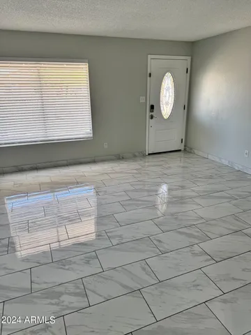 a view of a room with wooden floor and windows