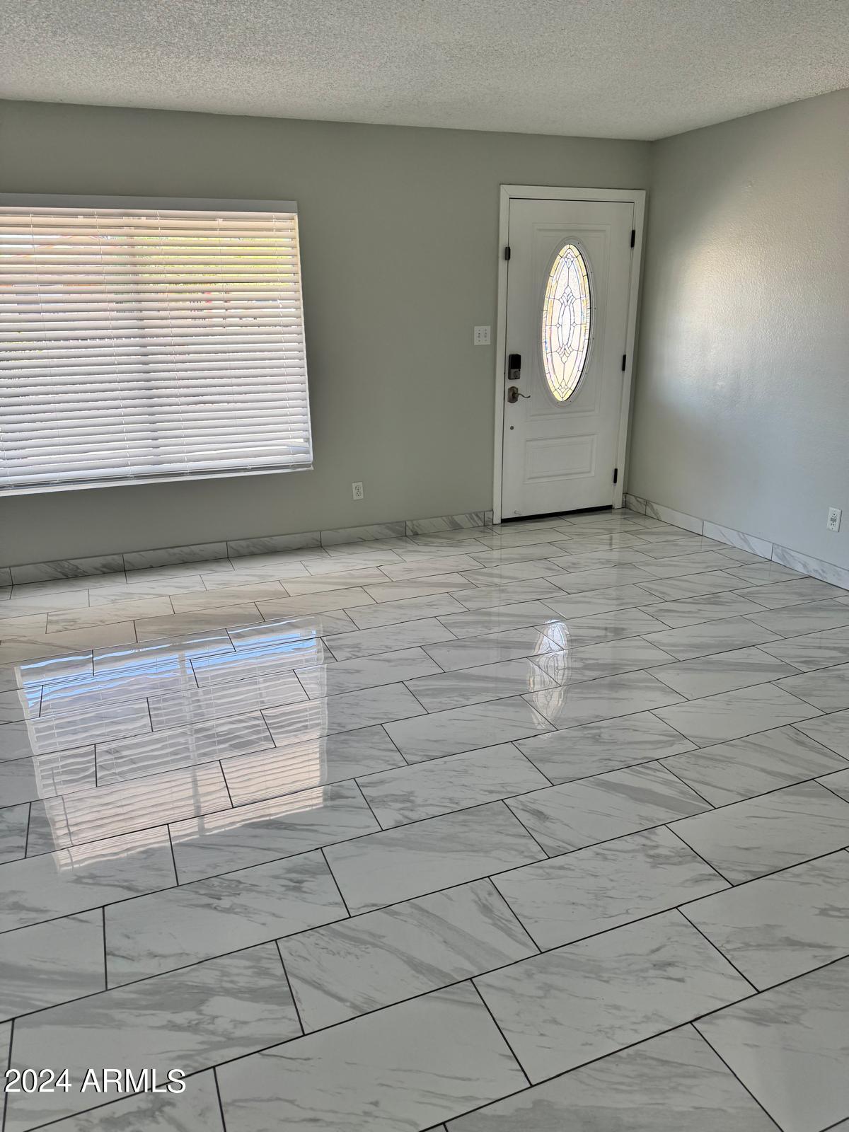 7209 West Luke Avenue Glendale, AZ 85303 - Photo 4 of 19 a view of a room with wooden floor and windows