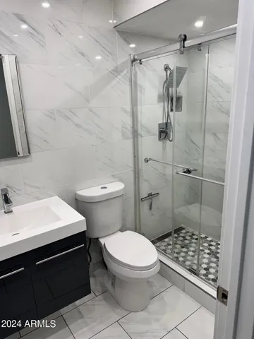 a bathroom with a sink toilet and shower