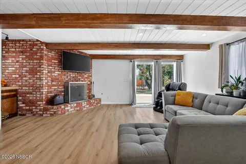a living room with furniture wooden floor and a fireplace