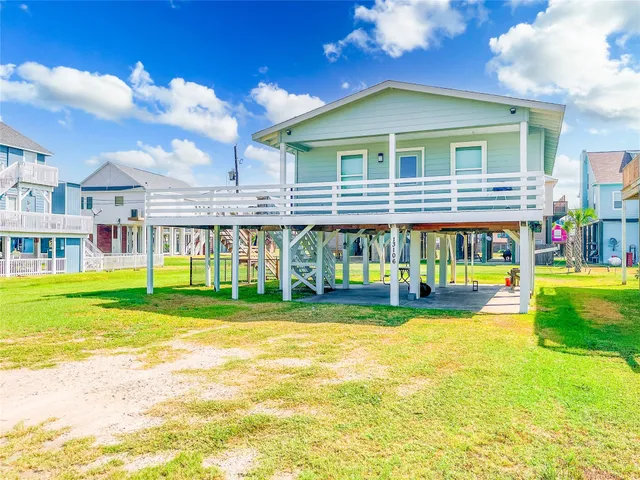 a view of a house with a yard and sitting area