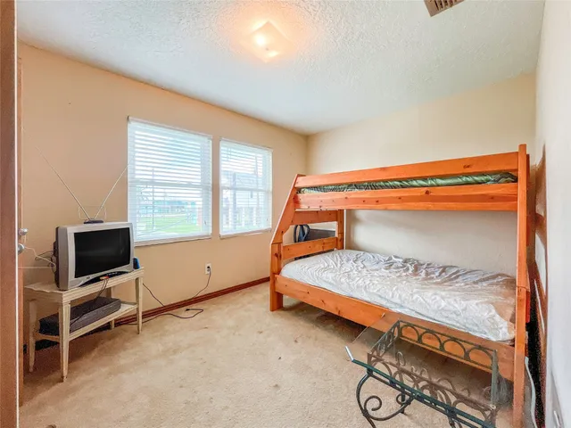 a bedroom with furniture and a window