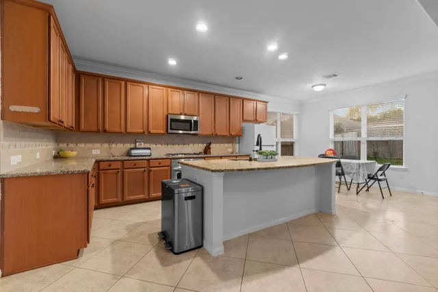 a kitchen with a sink a counter top space and appliances