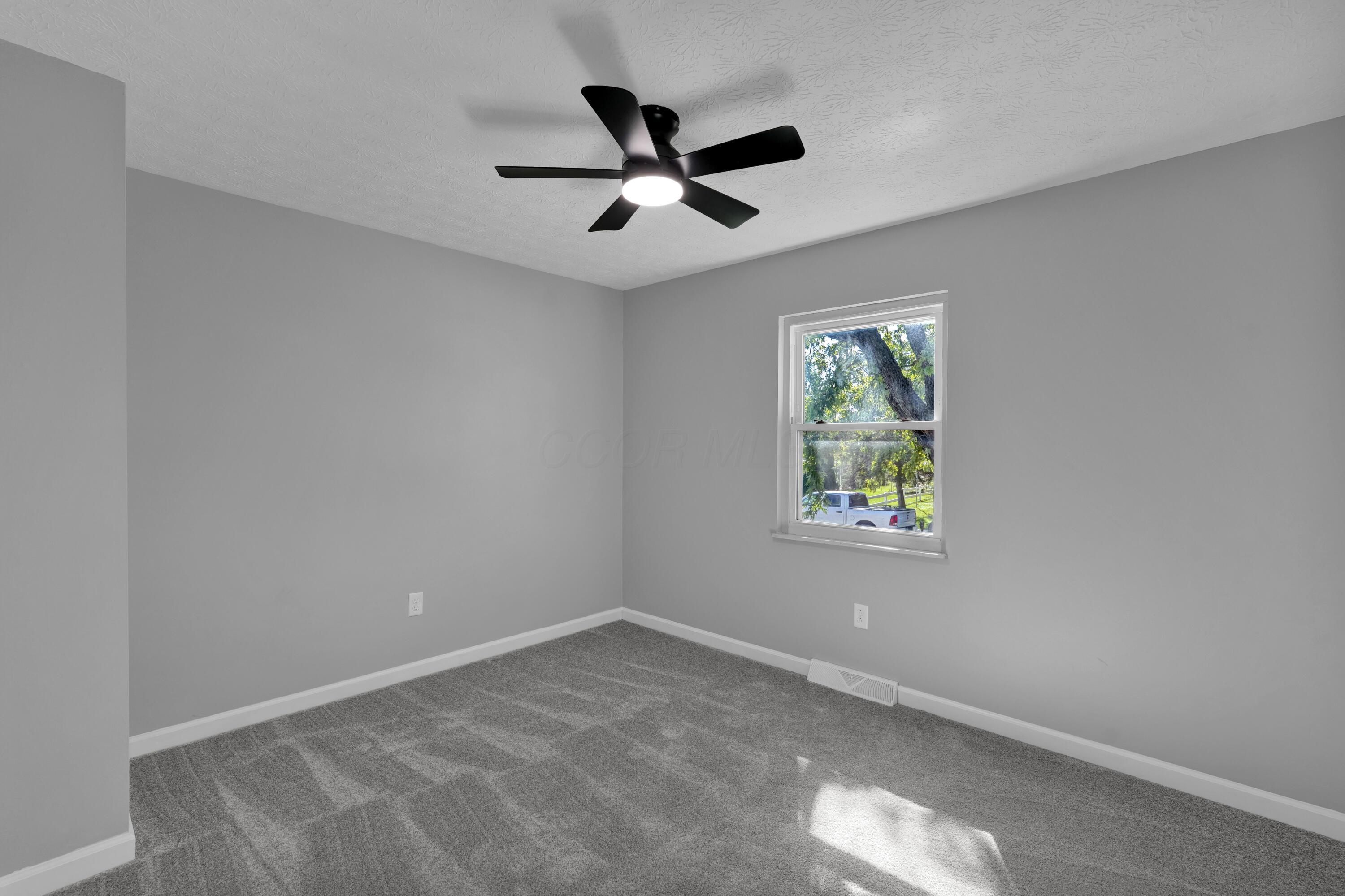 208 Cumberland Road Delaware, OH 43015 - Photo 12 of 37 Bedroom #1 faces the front of the home and has new carpet, paint, and light fixture (2026).