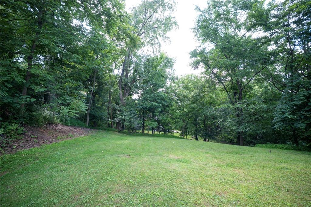 435 Cottage Lane Monroeville, PA 15146 - Photo 43 of 46 Level backyard surrounded by mature trees, creating a private setting for outdoor enjoyment.