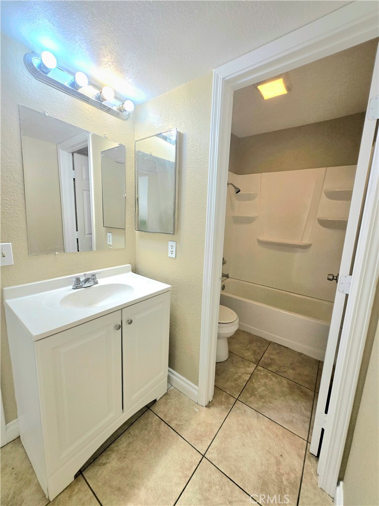 1118 Post Street, Unit B Redlands, CA 92374 - Photo 12 of 14 a bathroom with a double vanity sink toilet and shower