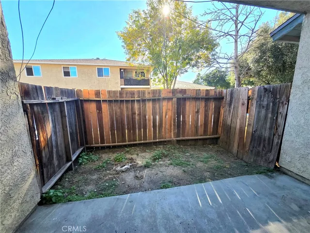 a view of a backyard with wooden fence