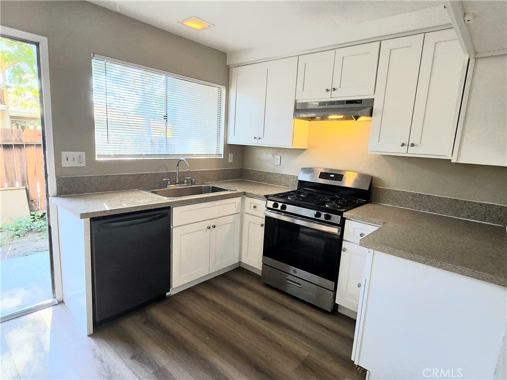 1118 Post Street, Unit B Redlands, CA 92374 - Photo 5 of 14 a kitchen with granite countertop white cabinets and appliances