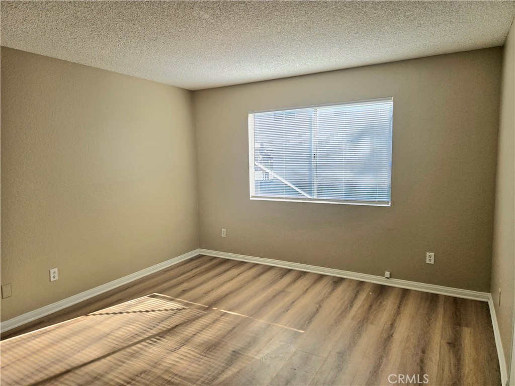 1118 Post Street, Unit B Redlands, CA 92374 - Photo 10 of 14 a view of a room with wooden floor and a window