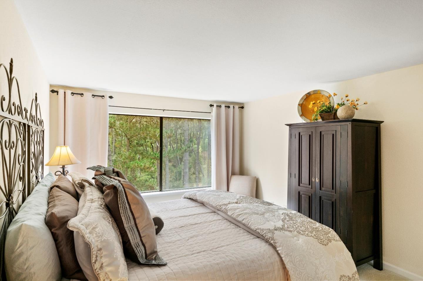51 Shepherds Knoll Road, Unit 51 Monterey, CA 93940 - Photo 14 of 18 a bed sitting in a bedroom next to a window
