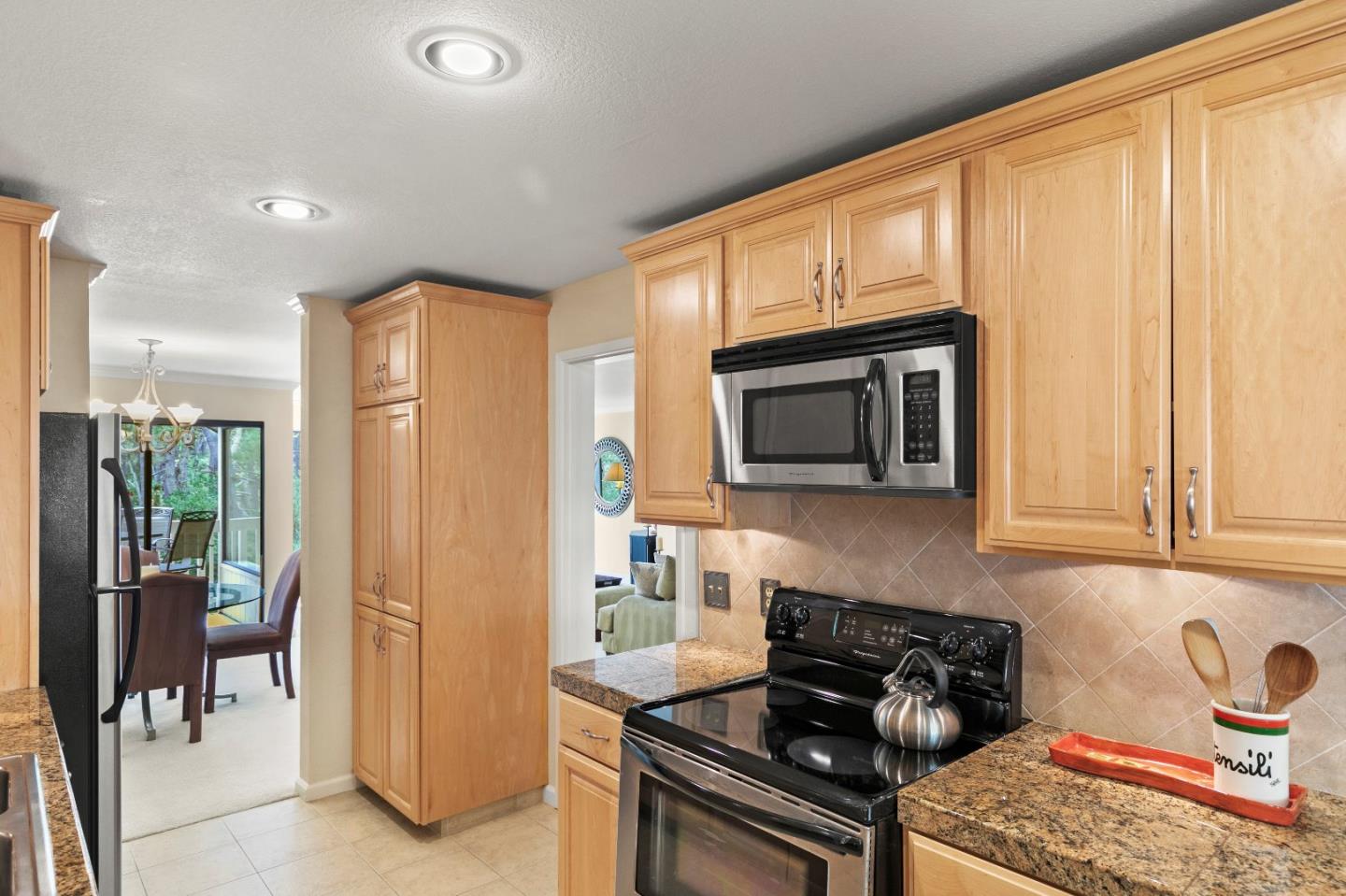 51 Shepherds Knoll Road, Unit 51 Monterey, CA 93940 - Photo 10 of 18 a kitchen with stainless steel appliances granite countertop a stove a sink and a microwave