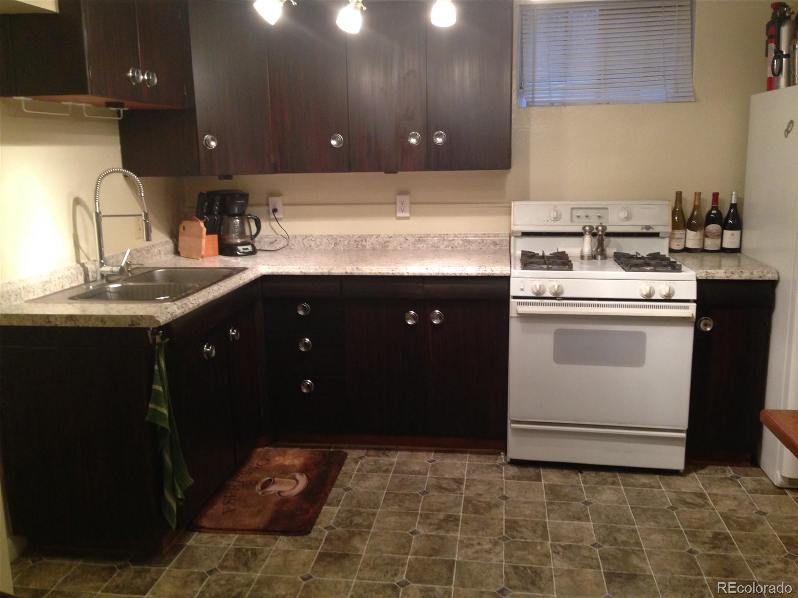 Undisclosed Address Denver, CO 80210 - Photo 12 of 31 a kitchen with a sink and a stove top oven