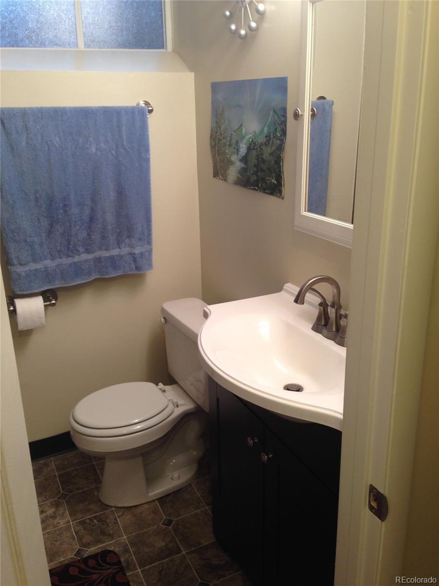 Undisclosed Address Denver, CO 80210 - Photo 14 of 31 a bathroom with a toilet a sink and mirror
