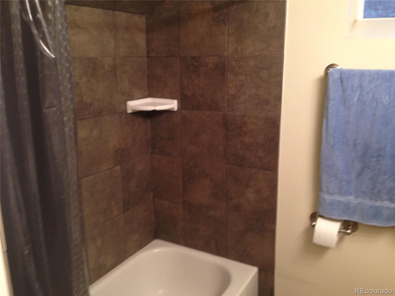 Undisclosed Address Denver, CO 80210 - Photo 15 of 31 a bathroom with a shower and a toilet