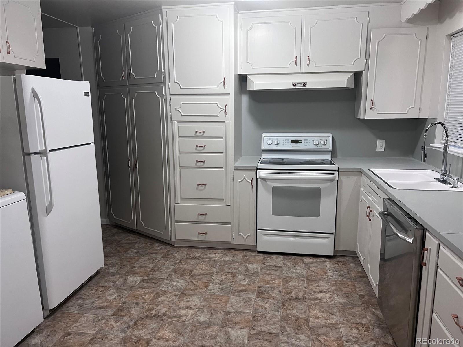 Undisclosed Address Denver, CO 80210 - Photo 19 of 31 a kitchen with a stove sink and a refrigerator