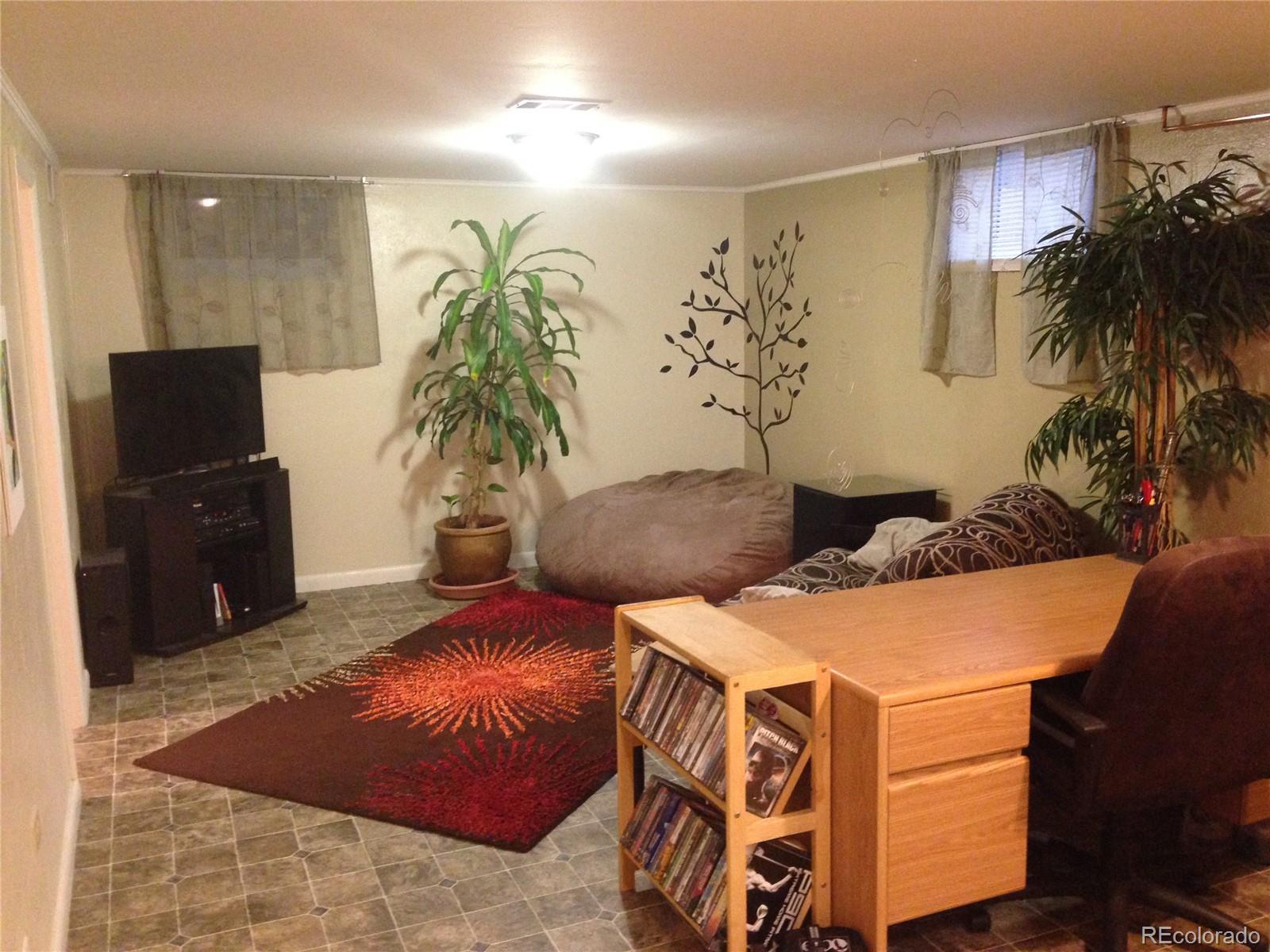 Undisclosed Address Denver, CO 80210 - Photo 9 of 31 a living room with furniture and a flat screen tv