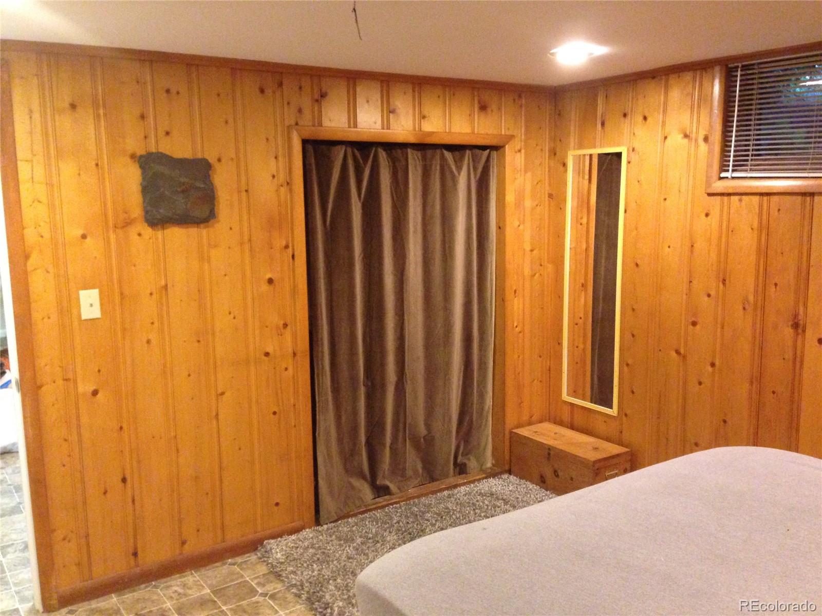 Undisclosed Address Denver, CO 80210 - Photo 10 of 31 a bedroom with a bed and a window