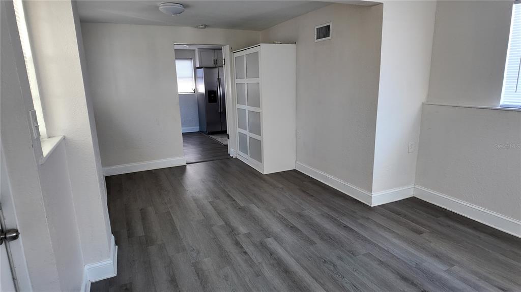 37530 Ferris Avenue Zephyrhills, FL 33542 - Photo 13 of 17 a view of an empty room with wooden floor and a window