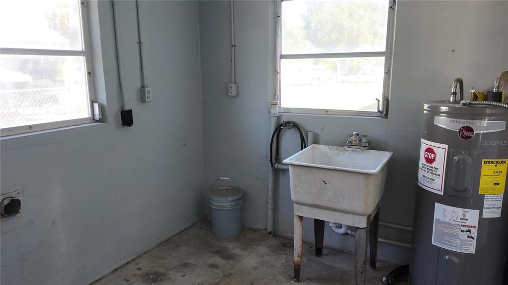 37530 Ferris Avenue Zephyrhills, FL 33542 - Photo 15 of 17 a bathroom with a toilet sink and window