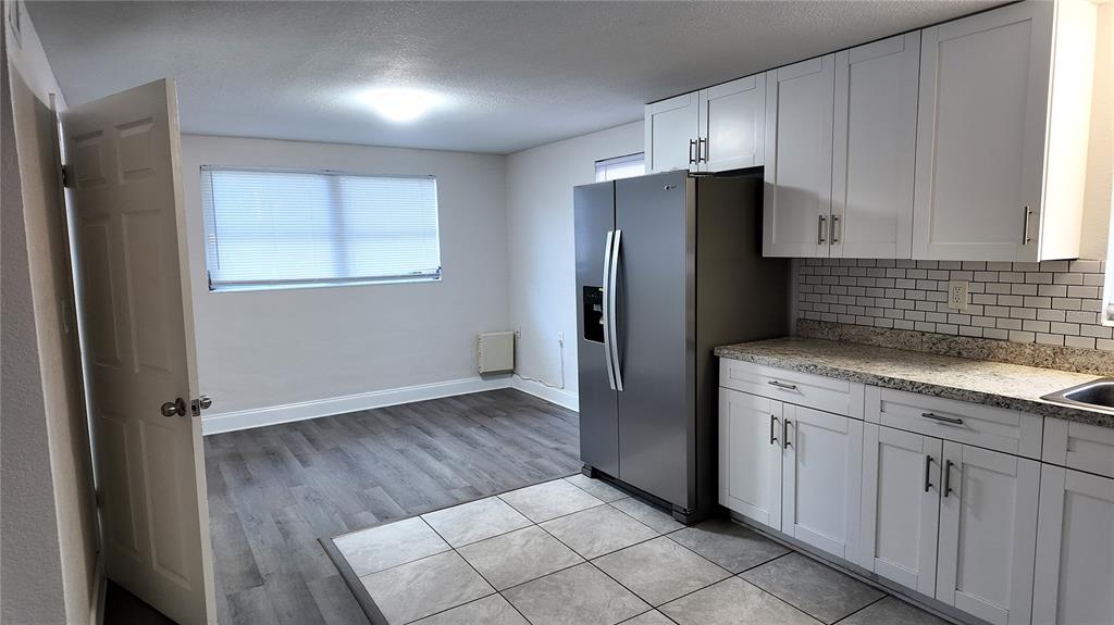 37530 Ferris Avenue Zephyrhills, FL 33542 - Photo 5 of 17 a kitchen with a refrigerator sink and cabinets