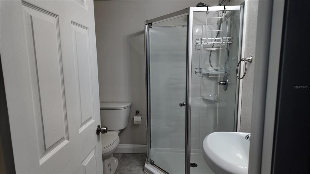 37530 Ferris Avenue Zephyrhills, FL 33542 - Photo 9 of 17 a bathroom with a granite countertop toilet and a shower