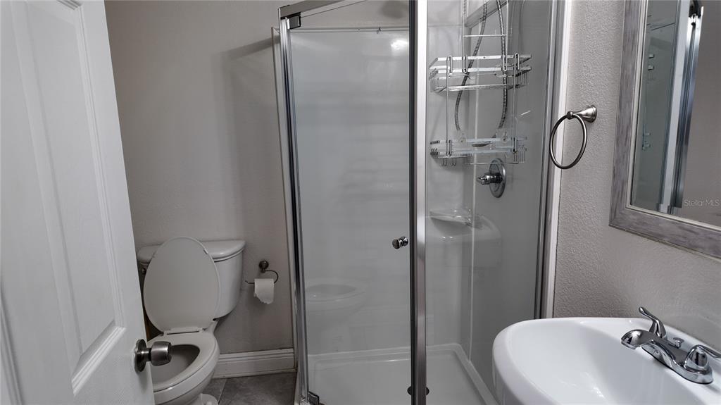 37530 Ferris Avenue Zephyrhills, FL 33542 - Photo 10 of 17 a bathroom with a sink a toilet and shower