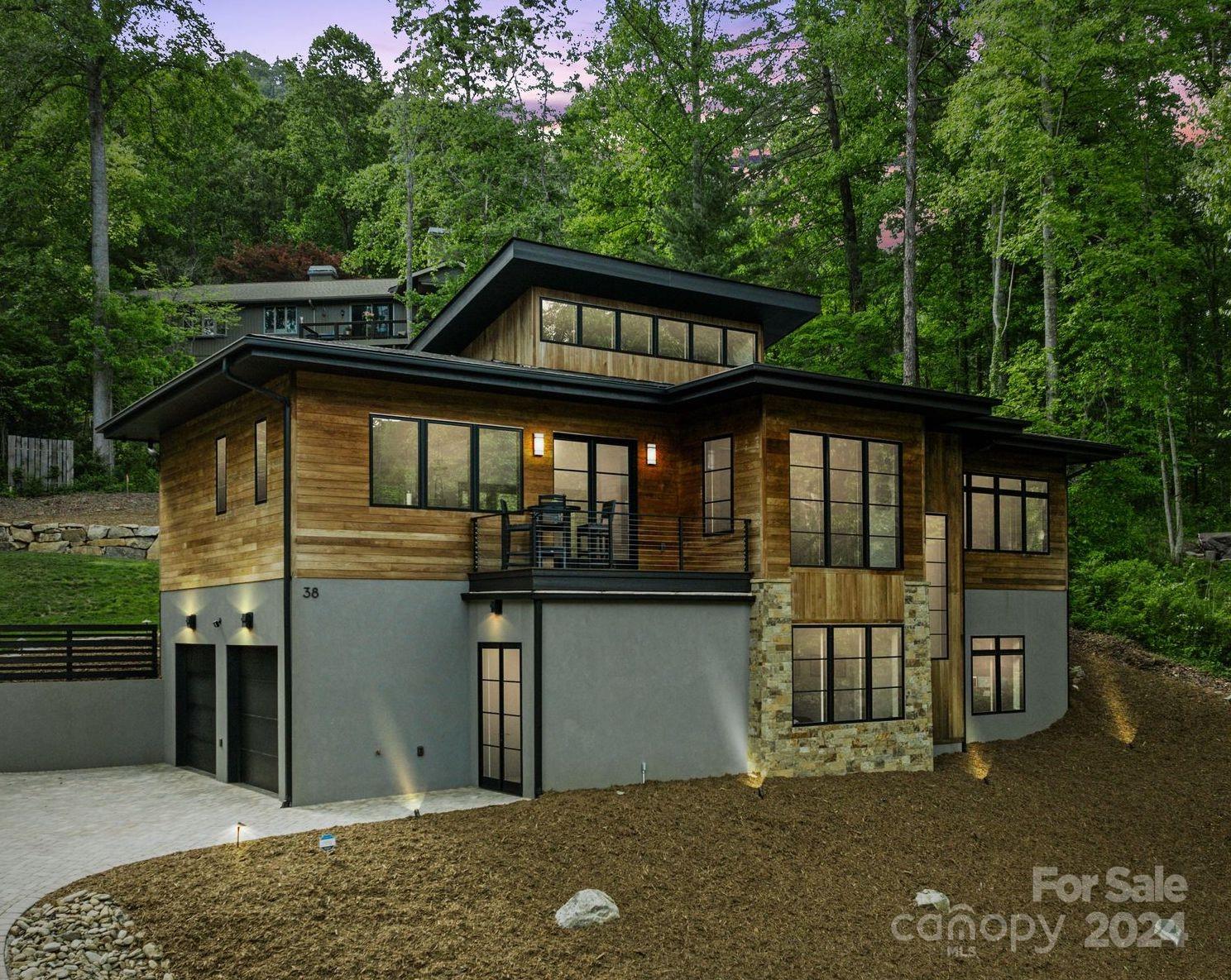 38 Brookwood Road Asheville, NC 28804 - Photo 1 of 45 a front view of a house with a garden