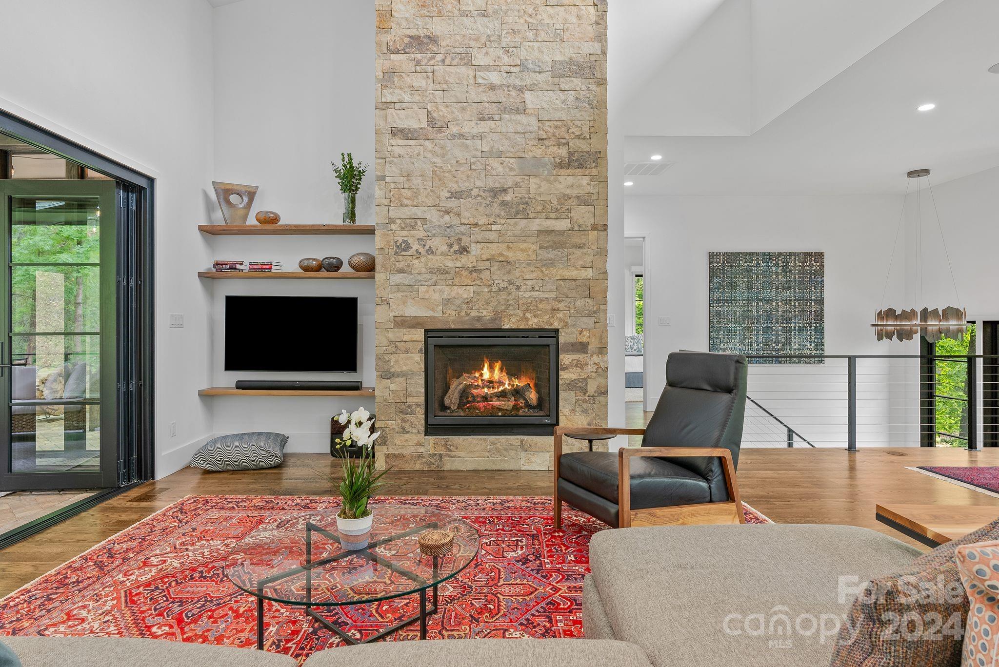 38 Brookwood Road Asheville, NC 28804 - Photo 19 of 45 a living room with furniture a flat screen tv and a fireplace