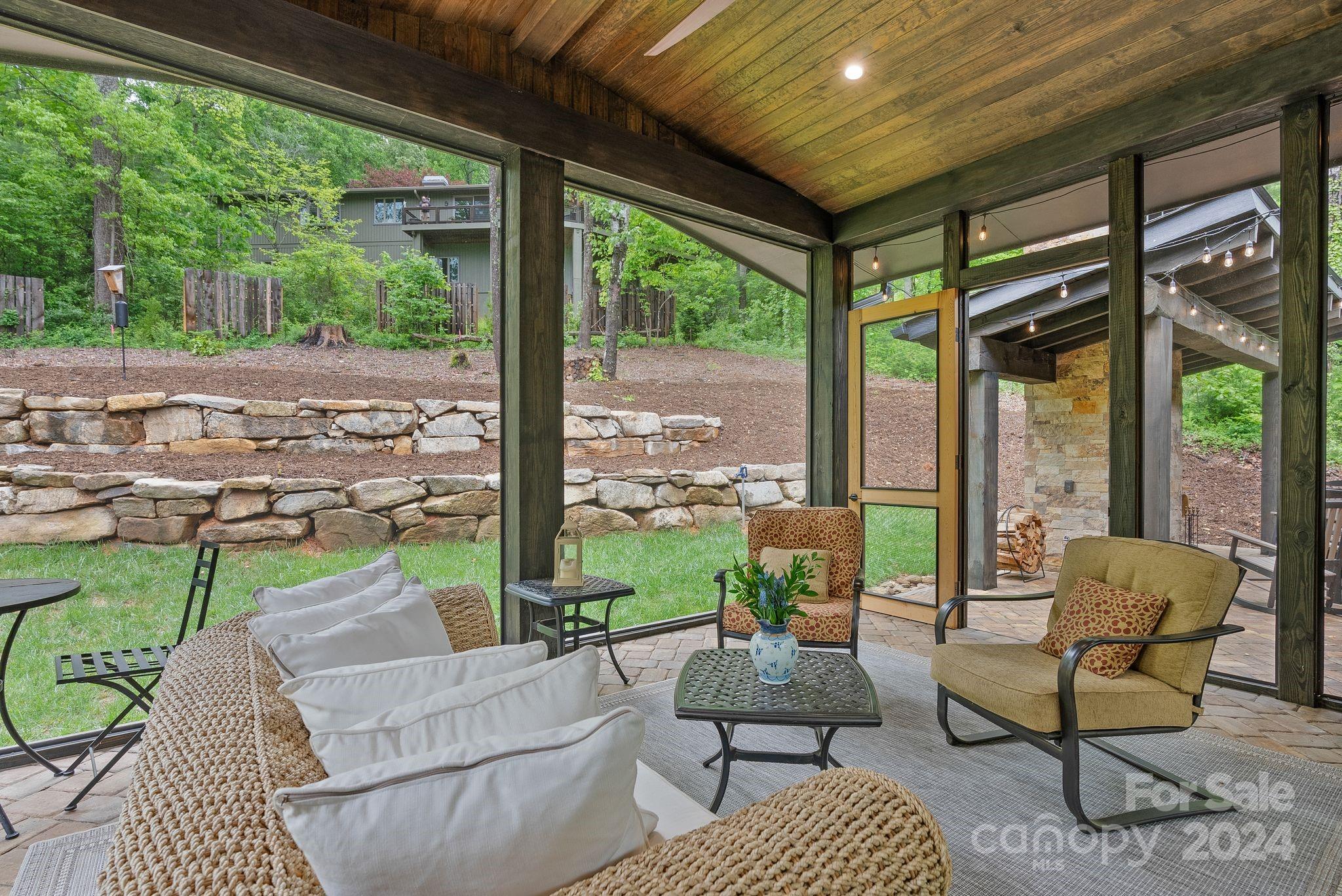 38 Brookwood Road Asheville, NC 28804 - Photo 22 of 45 a living room with patio furniture and a floor to ceiling window