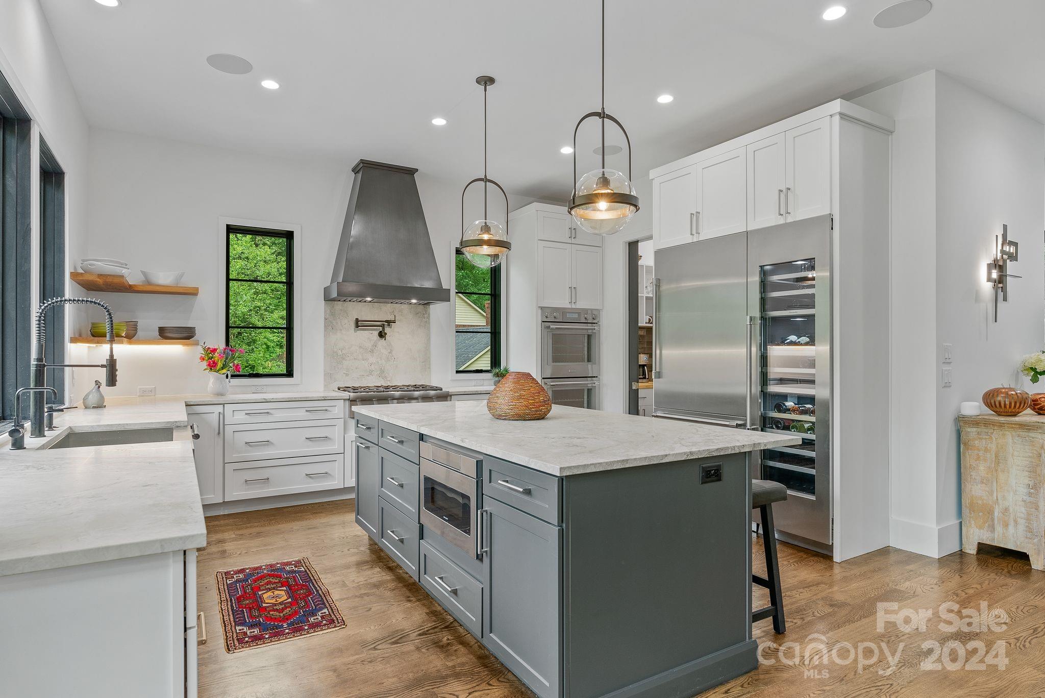 38 Brookwood Road Asheville, NC 28804 - Photo 5 of 45 a kitchen with kitchen island granite countertop a sink stainless steel appliances and cabinets