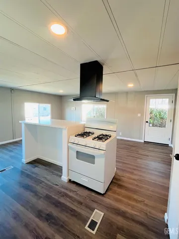 a kitchen with sink cabinets and wooden floor