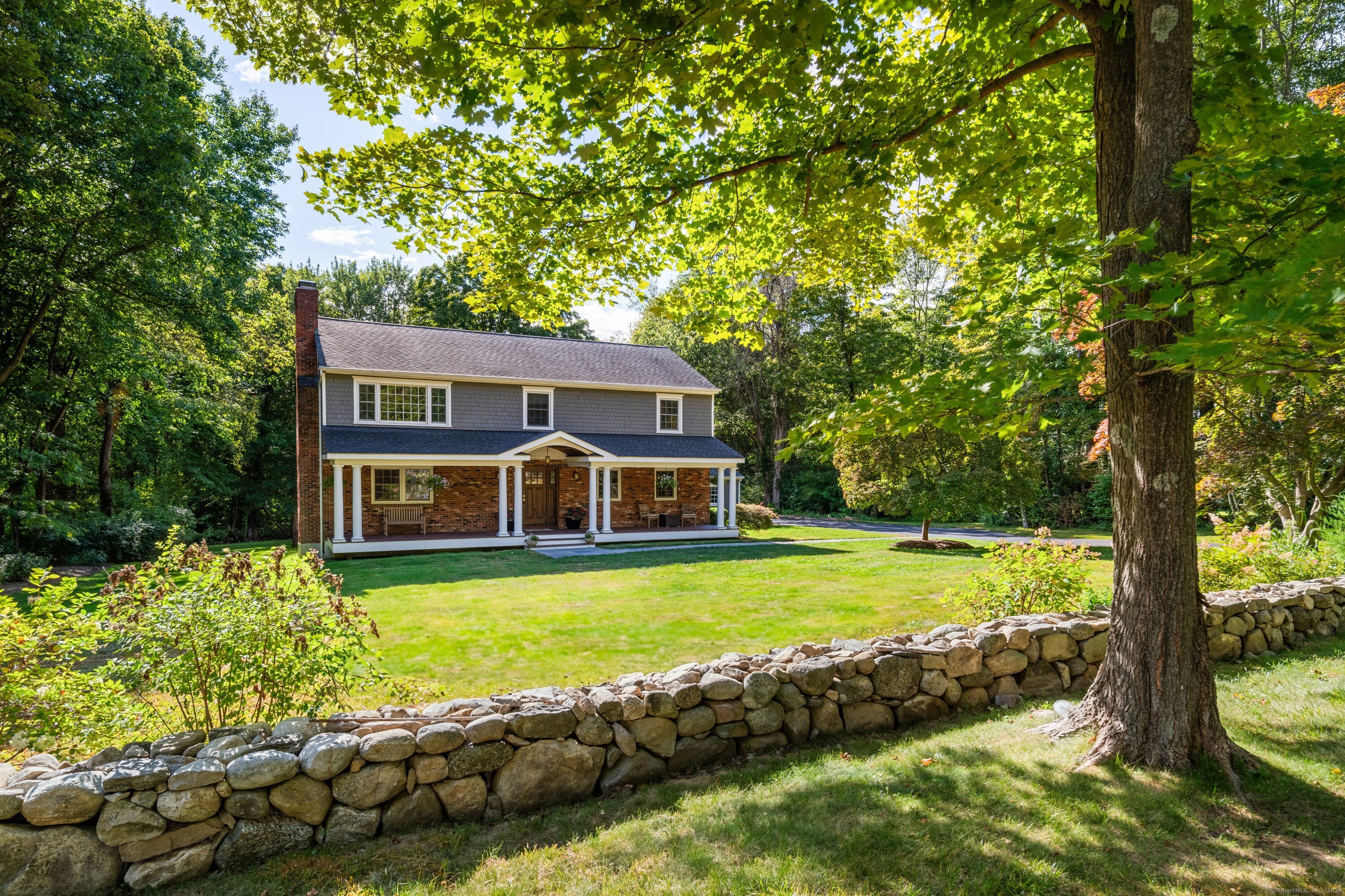 a house with a big yard and large trees