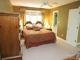 5809 Ventry Court Raleigh, NC 27613 - Photo 3 of 9 a bedroom with a bed and wooden floor